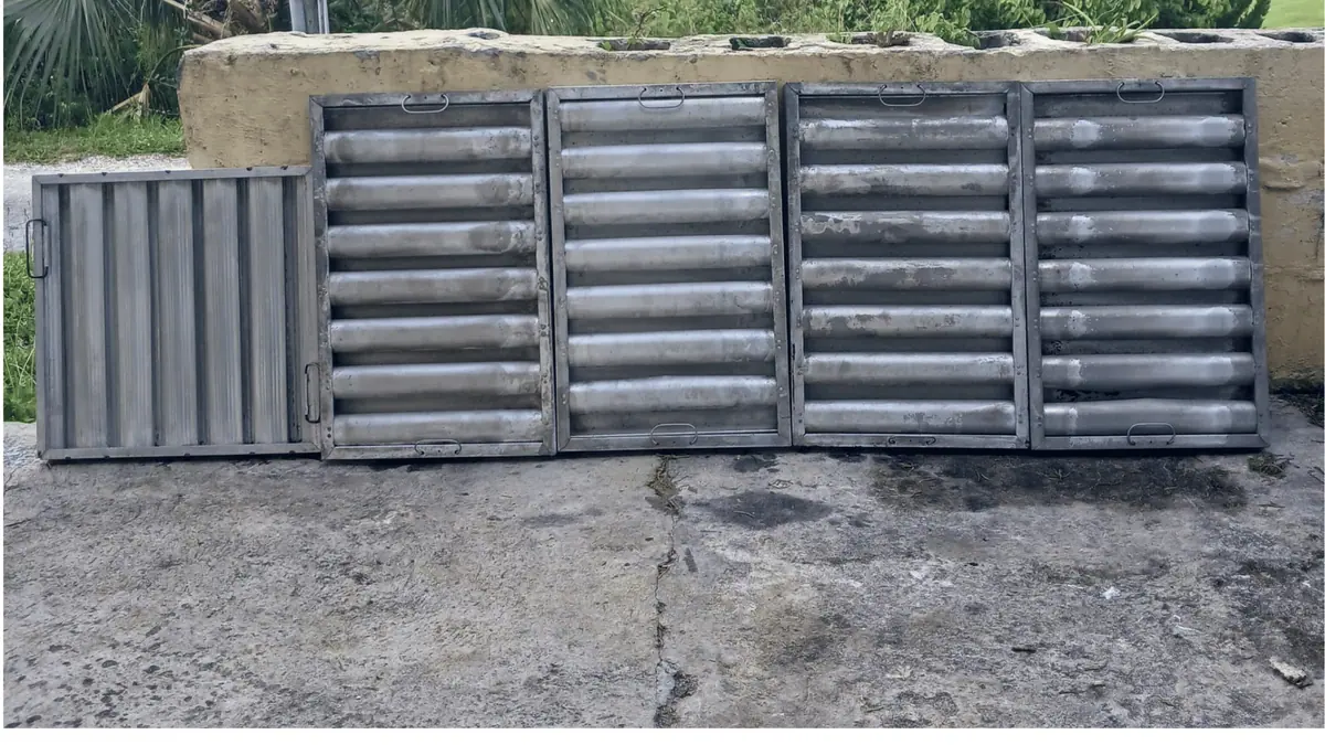 The same grease filters after cleaning, restored to bare metal